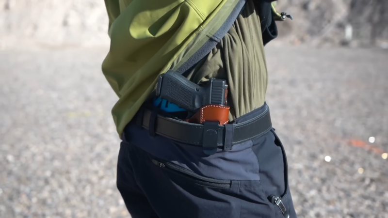 A Man Wearing a Leather Holster for His Firearm