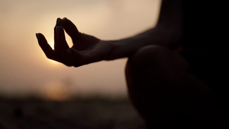 A woman meditating in the Golden Hour