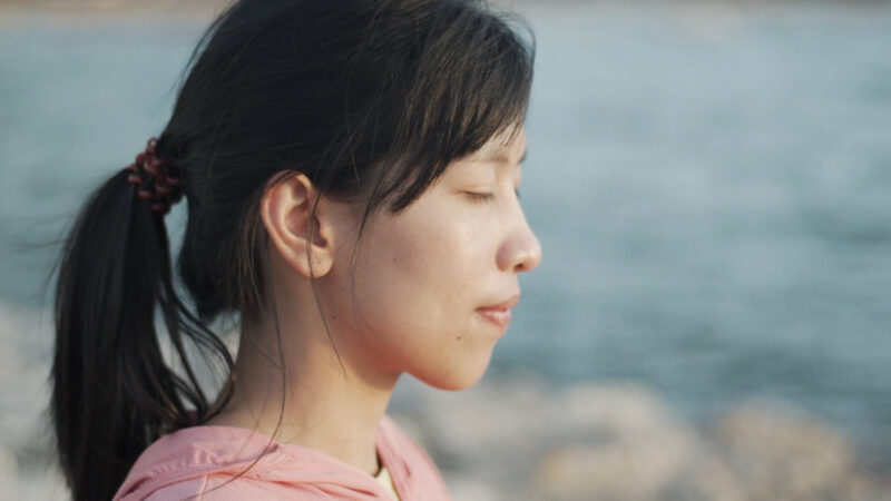 A girl meditating by the river