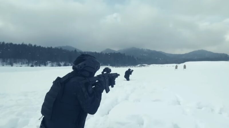 Two Individuals Conducting Tactical Training Exercises in A Snowy Landscape, Aiming Their Rifles Towards Targets