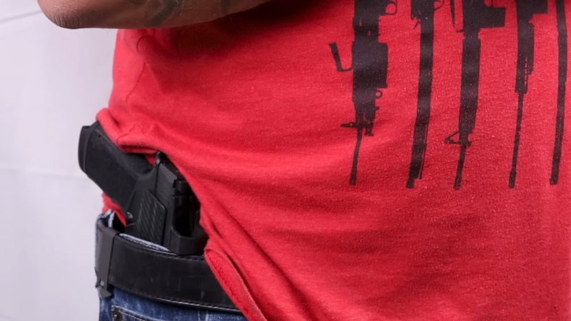 A Close-Up of A Firearm Concealed in A Holster