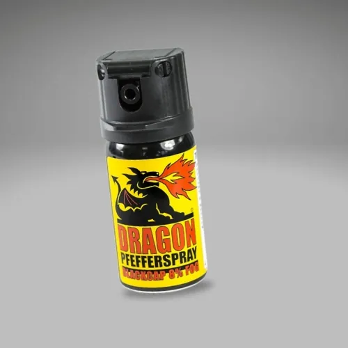 A small canister of Dragon Pfefferspray with a yellow label featuring a fire-breathing dragon and a black nozzle, set against a neutral gray background